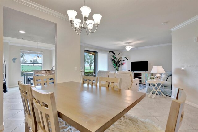 5528 Palmer Cir Unit 104, Bradenton, FL 34211 - dining room with light tile patterned flooring, a chandelier, crown molding, baseboards, and a ceiling fan