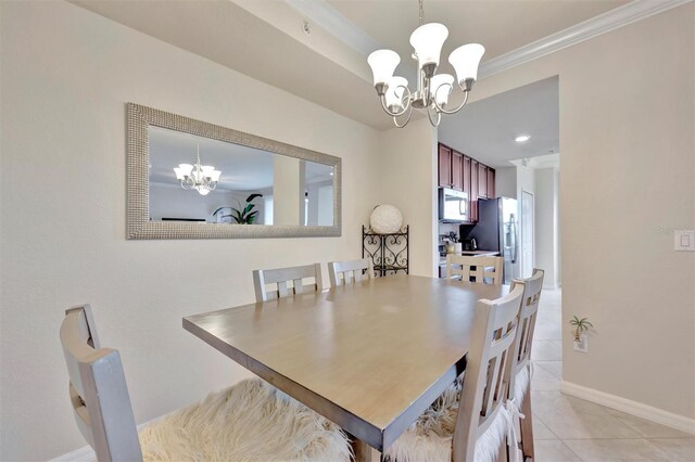 5528 Palmer Cir Unit 104, Bradenton, FL 34211 - dining area featuring a chandelier, light tile patterned floors, crown molding, and baseboards