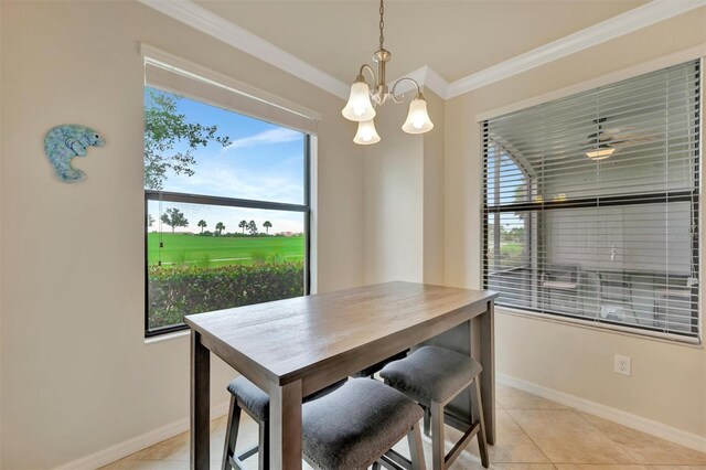 5528 Palmer Cir Unit 104, Bradenton, FL 34211 - dining area featuring a chandelier, crown molding, baseboards, healthy amount of natural light, and light tile patterned flooring
