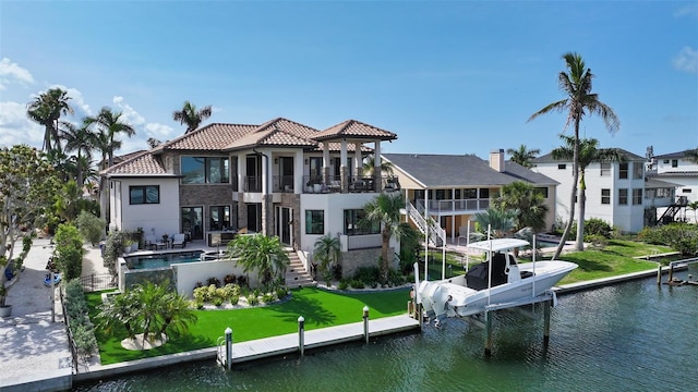 795 Marbury Ln, Longboat Key, FL 34228 - rear view of house with a balcony, stairs, a water view, and a tiled roof
