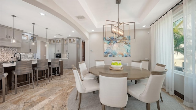 795 Marbury Ln, Longboat Key, FL 34228 - dining space with recessed lighting, a chandelier, wet bar, arched walkways, and light stone finish floors