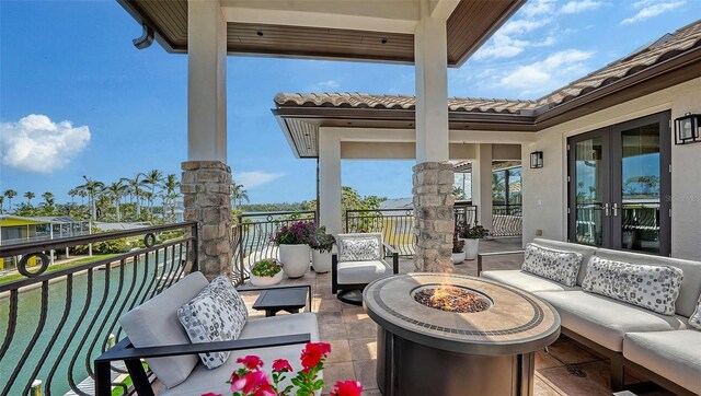 795 Marbury Ln, Longboat Key, FL 34228 - view of patio / terrace featuring french doors and an outdoor living space with a fire pit