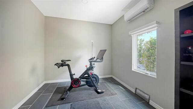 795 Marbury Ln, Longboat Key, FL 34228 - workout room with an AC wall unit and dark tile patterned flooring