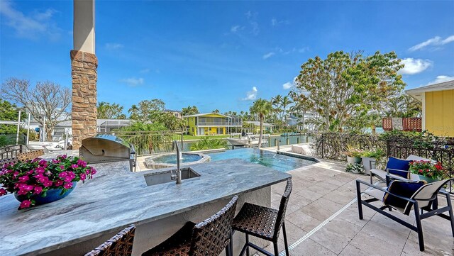 795 Marbury Ln, Longboat Key, FL 34228 - view of patio / terrace featuring exterior kitchen and an outdoor pool