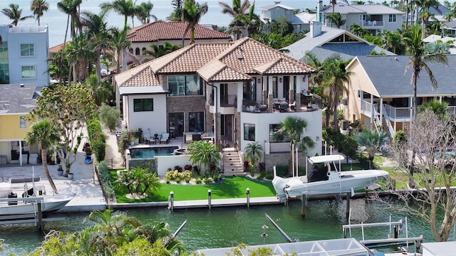 795 Marbury Ln, Longboat Key, FL 34228 - back of house featuring a balcony, a tiled roof, a water view, a residential view, and boat lift