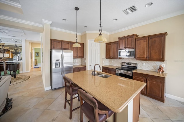 305 Siena Vista Pl, Sun City Center, FL 33573 - kitchen featuring appliances with stainless steel finishes, light stone counters, a breakfast bar area, light tile patterned flooring, and ornamental molding