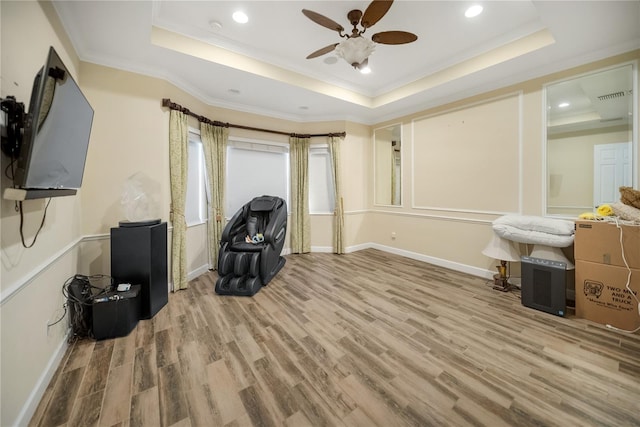 305 Siena Vista Pl, Sun City Center, FL 33573 - living area featuring a tray ceiling, a ceiling fan, wood finished floors, ornamental molding, and recessed lighting