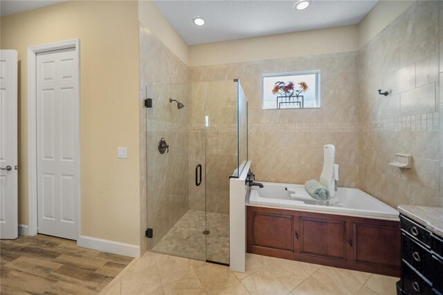 305 Siena Vista Pl, Sun City Center, FL 33573 - full bathroom featuring a garden tub, a shower stall, recessed lighting, and wood finished floors