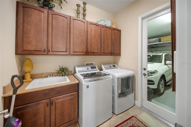 305 Siena Vista Pl, Sun City Center, FL 33573 - washroom with separate washer and dryer, cabinet space, and light tile patterned flooring