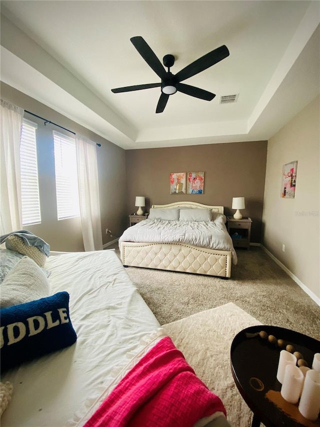 11613 Woodleaf Dr, Lakewood Ranch, FL 34211 - carpeted bedroom with a raised ceiling and a ceiling fan