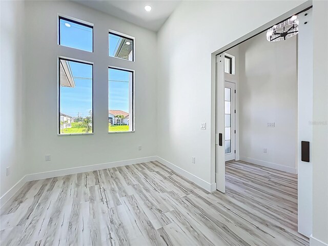 1167 Boundary Blvd, Rotonda West, FL 33947 - unfurnished room with light wood finished floors and recessed lighting