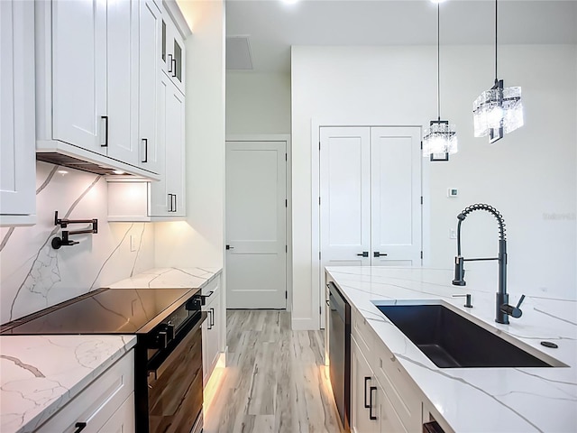 1167 Boundary Blvd, Rotonda West, FL 33947 - kitchen featuring black electric range oven, stainless steel dishwasher, decorative backsplash, light wood-type flooring, and white cabinets