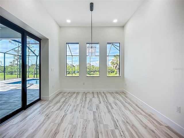 1167 Boundary Blvd, Rotonda West, FL 33947 - unfurnished dining area with healthy amount of natural light, light wood-type flooring, and recessed lighting