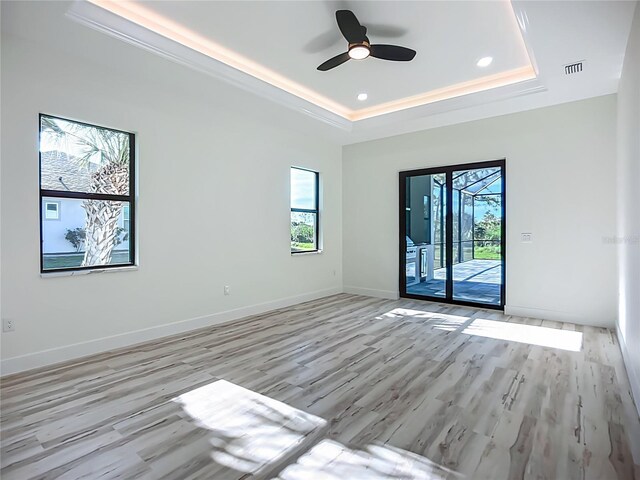 1167 Boundary Blvd, Rotonda West, FL 33947 - unfurnished room with a raised ceiling, a ceiling fan, light wood-type flooring, and recessed lighting