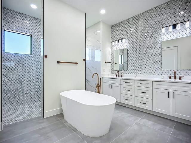 1167 Boundary Blvd, Rotonda West, FL 33947 - full bath featuring tile patterned flooring, tiled shower, a freestanding bath, double vanity, and tile walls