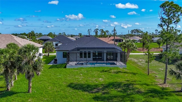 1167 Boundary Blvd, Rotonda West, FL 33947 - rear view of house featuring a yard, an outdoor pool, a patio, glass enclosure, and a residential view