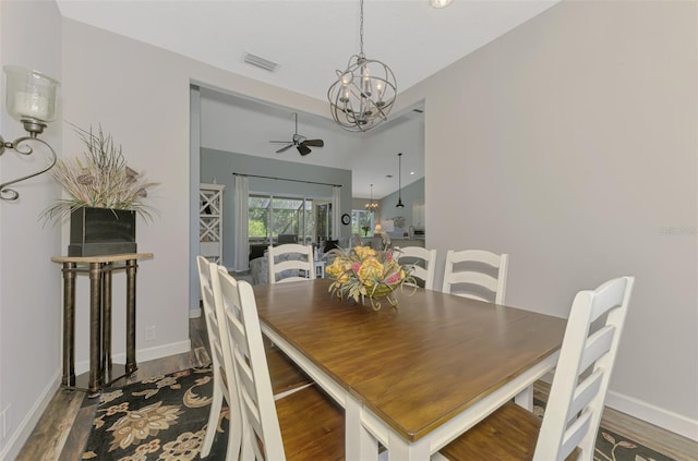 7302 Dunes Ct, Bradenton, FL 34202 - dining space with a ceiling fan, wood finished floors, a chandelier, and vaulted ceiling
