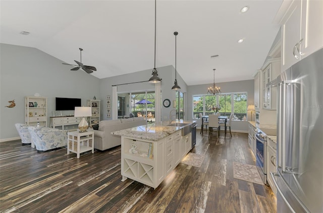 7302 Dunes Ct, Bradenton, FL 34202 - kitchen featuring stainless steel appliances, dark wood-type flooring, white cabinets, healthy amount of natural light, and recessed lighting