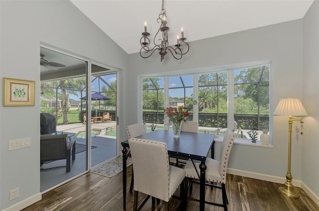 7302 Dunes Ct, Bradenton, FL 34202 - dining space with dark wood-type flooring, a chandelier, and vaulted ceiling