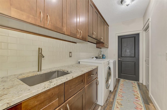7302 Dunes Ct, Bradenton, FL 34202 - laundry room featuring cabinet space, separate washer and dryer, and a textured ceiling