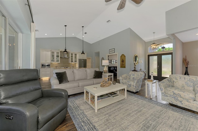 7302 Dunes Ct, Bradenton, FL 34202 - living room featuring dark wood finished floors, french doors, high vaulted ceiling, and a ceiling fan