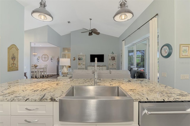 7302 Dunes Ct, Bradenton, FL 34202 - kitchen featuring stainless steel dishwasher, ceiling fan, light stone countertops, open floor plan, and high vaulted ceiling