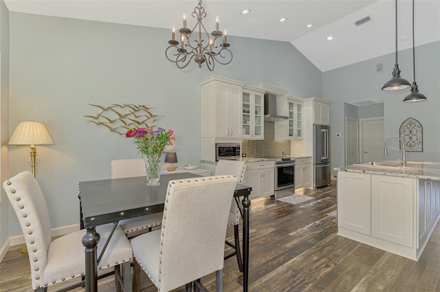 7302 Dunes Ct, Bradenton, FL 34202 - dining space with high vaulted ceiling, a chandelier, dark wood-type flooring, and recessed lighting