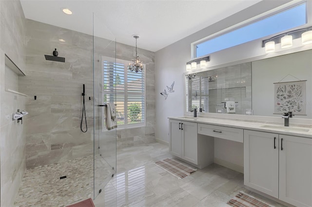 7302 Dunes Ct, Bradenton, FL 34202 - bathroom with double vanity, a tile shower, marble look tile flooring, and a chandelier