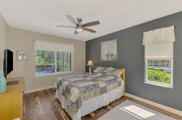 7302 Dunes Ct, Bradenton, FL 34202 - bedroom featuring wood finished floors and a ceiling fan