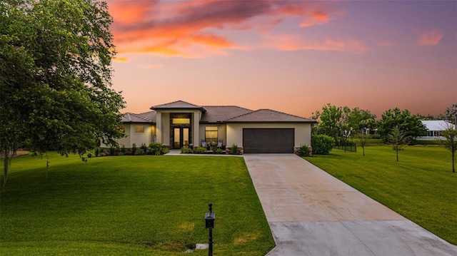 16630 Willow Point Ct, Alva, FL 33920 - view of front of home with concrete driveway, a lawn, stucco siding, an attached garage, and a tiled roof