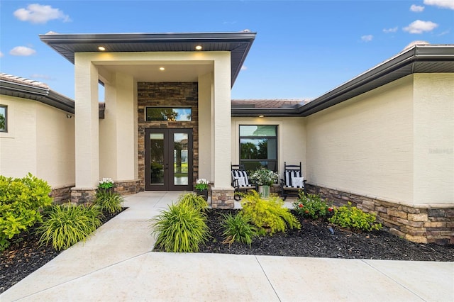 16630 Willow Point Ct, Alva, FL 33920 - property entrance with french doors, stone siding, and stucco siding