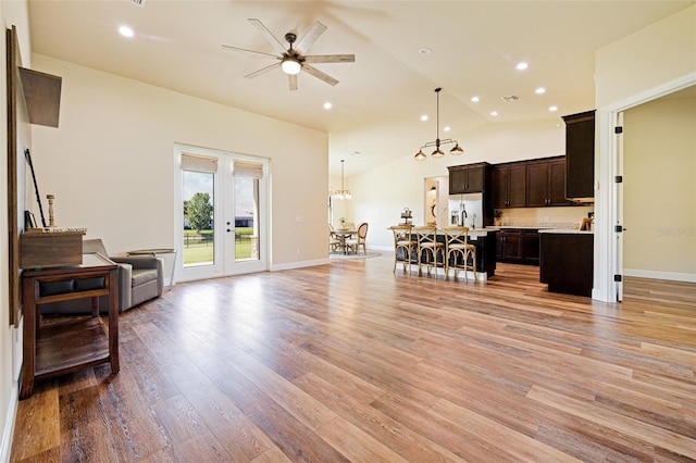 16630 Willow Point Ct, Alva, FL 33920 - living room featuring lofted ceiling, ceiling fan, light wood-style flooring, french doors, and recessed lighting