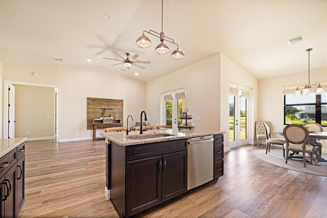 16630 Willow Point Ct, Alva, FL 33920 - kitchen with dishwasher, lofted ceiling, a sink, light wood-style flooring, and a center island with sink