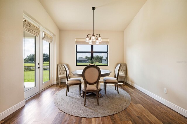 16630 Willow Point Ct, Alva, FL 33920 - dining space with a chandelier, wood finished floors, and baseboards