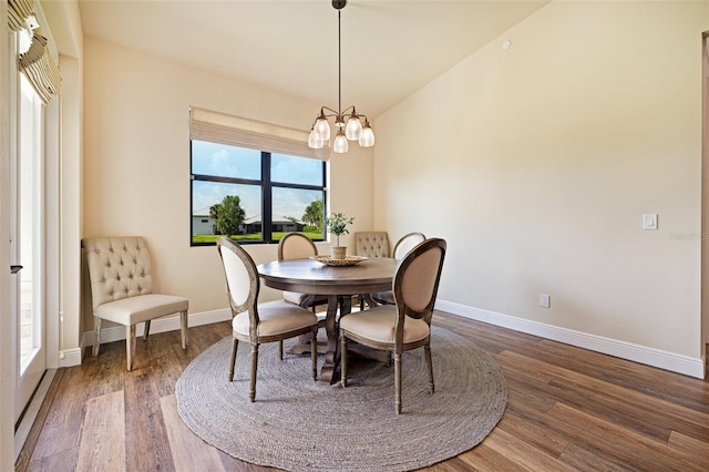 16630 Willow Point Ct, Alva, FL 33920 - dining room featuring wood finished floors, baseboards, a chandelier, and lofted ceiling