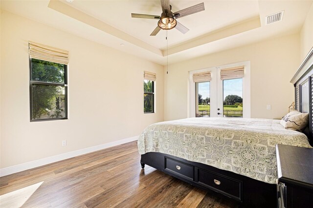 16630 Willow Point Ct, Alva, FL 33920 - bedroom featuring a raised ceiling, access to outside, wood finished floors, french doors, and baseboards