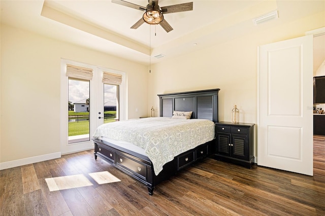 16630 Willow Point Ct, Alva, FL 33920 - bedroom featuring dark wood-type flooring, access to outside, a tray ceiling, baseboards, and ceiling fan
