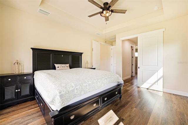 16630 Willow Point Ct, Alva, FL 33920 - bedroom featuring a tray ceiling, wood finished floors, baseboards, and a ceiling fan