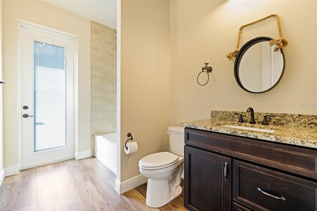 16630 Willow Point Ct, Alva, FL 33920 - full bathroom featuring vanity, wood finished floors, toilet, and baseboards
