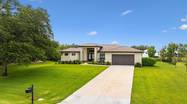 16630 Willow Point Ct, Alva, FL 33920 - view of front of property with a garage, stucco siding, a front lawn, driveway, and a tile roof