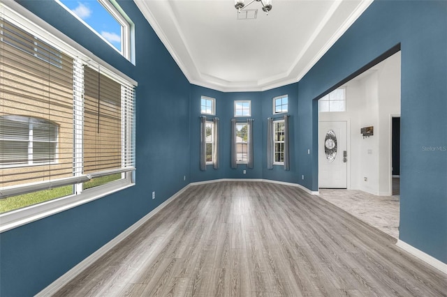 2347 123rd Pl E, Parrish, FL 34219 - foyer featuring wood finished floors, healthy amount of natural light, a towering ceiling, and crown molding