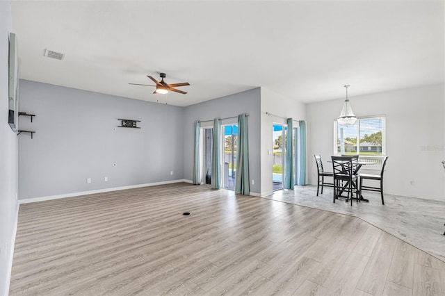2347 123rd Pl E, Parrish, FL 34219 - living area featuring light wood-style floors, a ceiling fan, and a chandelier