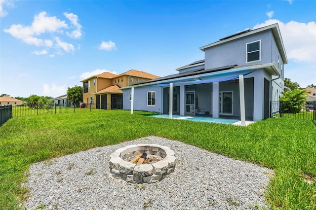 2347 123rd Pl E, Parrish, FL 34219 - rear view of house with an outdoor fire pit, stucco siding, a patio, a fenced backyard, and a ceiling fan