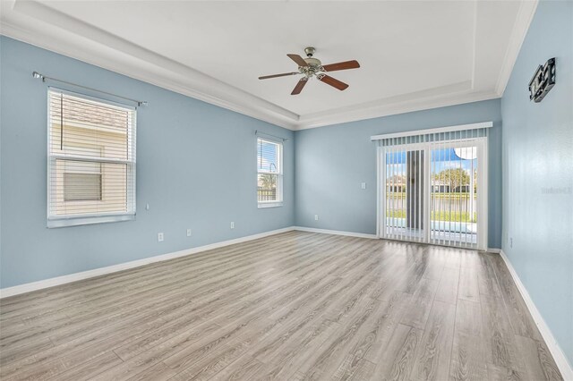 2347 123rd Pl E, Parrish, FL 34219 - unfurnished room with a tray ceiling, light wood-style flooring, ceiling fan, and ornamental molding