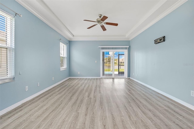 2347 123rd Pl E, Parrish, FL 34219 - spare room featuring ceiling fan, light wood finished floors, a tray ceiling, and ornamental molding