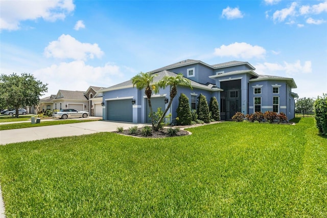 2347 123rd Pl E, Parrish, FL 34219 - view of front of house featuring stucco siding, driveway, a garage, and a front lawn