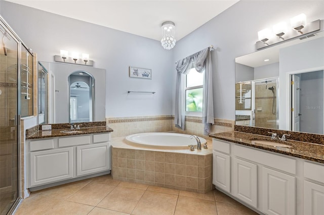 2347 123rd Pl E, Parrish, FL 34219 - bathroom featuring a shower stall, two vanities, tile patterned floors, and a bath
