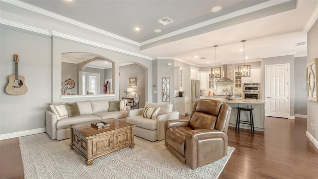 13220 Swiftwater Way, Lakewood Ranch, FL 34211 - living area featuring arched walkways, recessed lighting, wood finished floors, and ornamental molding