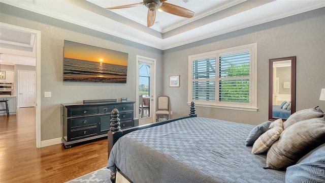 13220 Swiftwater Way, Lakewood Ranch, FL 34211 - bedroom with wood finished floors, ornamental molding, access to outside, a raised ceiling, and ensuite bathroom