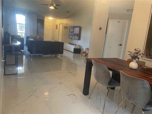 5848 Milton Ave, Sarasota, FL 34243 - dining space featuring light marble finish floors, ceiling fan, and vaulted ceiling